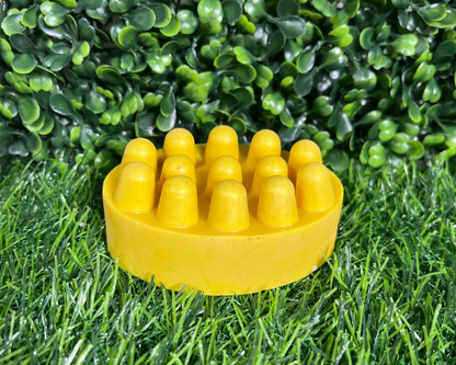 Scrub bar of turmeric soap on a leaf like surface.