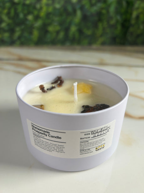 Candle in a medium white tin container with a label 