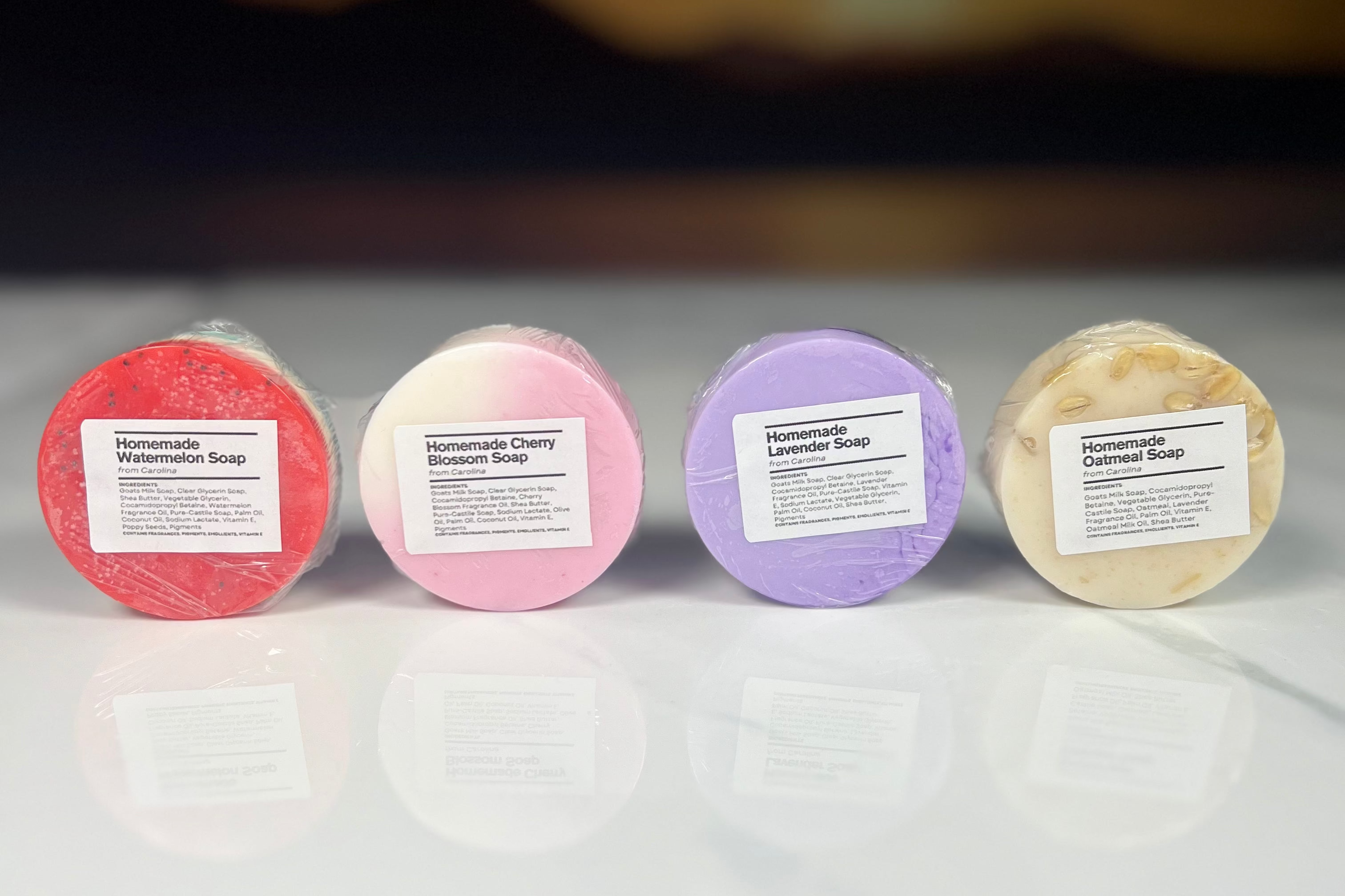 Four multicolored circular bars of soap